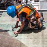 man-wearing-blue-hard-hat-using-hammer-544966